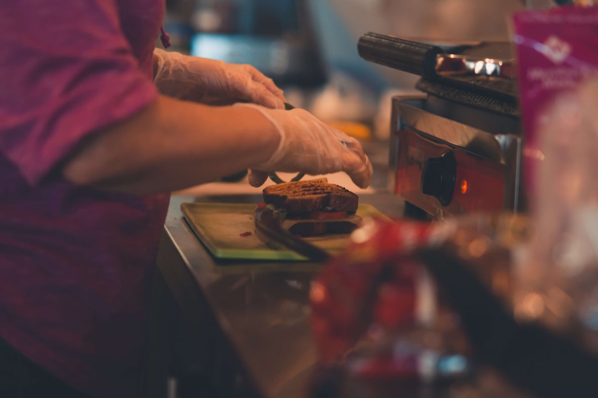 Cafe worker wearing disposable gloves